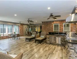a living room with a brick wall and a fireplace