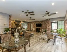 a room with a brick fireplace and dining table