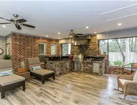 a living room with a brick wall and a fireplace