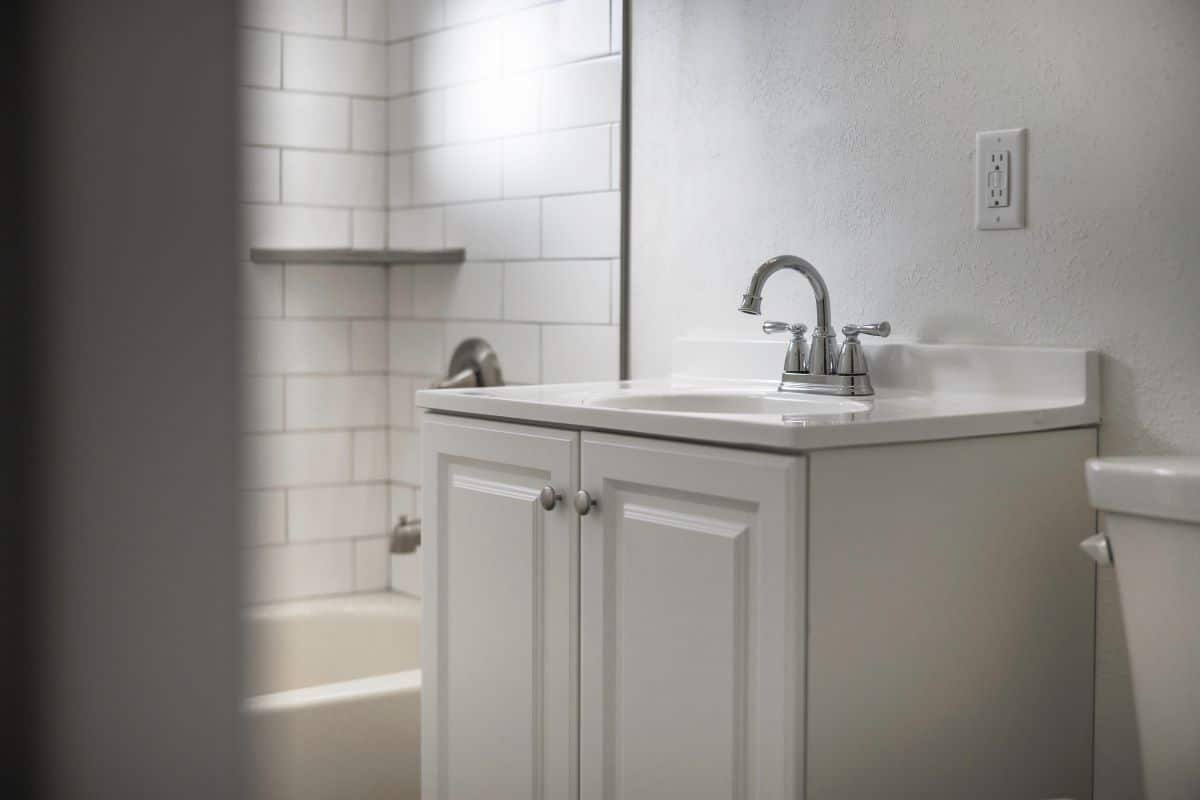 sink and cabin of a new renovated white bathroom