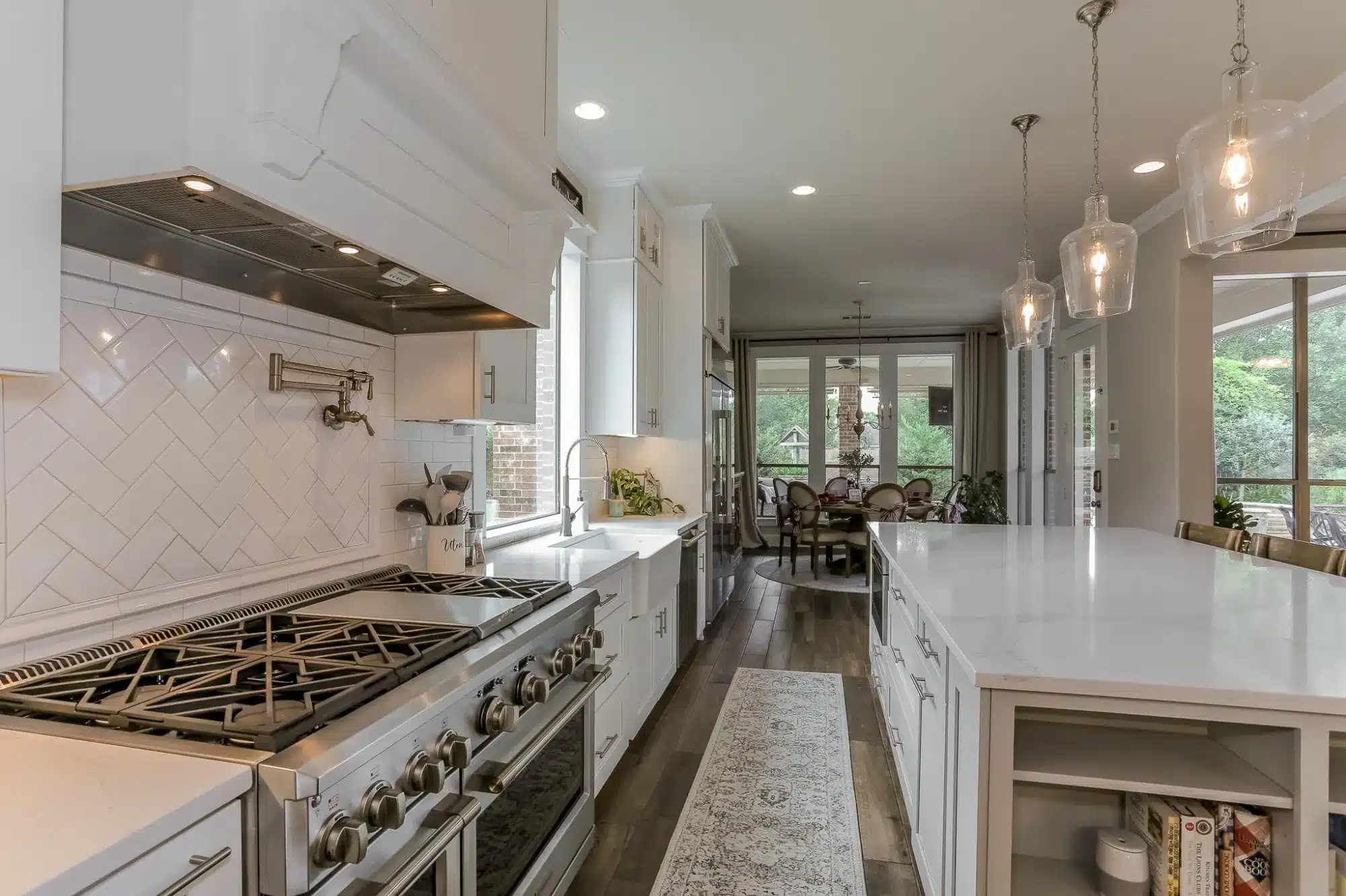 Image of dwr interiors kitchen remodel quartz island open shelves stainless fridge farmhouse sink houston, tx.